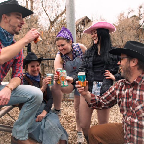 A group of 5 individuals sharing a cold drink dressed up for the Hogle Hoedown Zoo Brew at Utah's Hogle Zoo