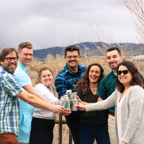 A group of friends cheers at the top of Utah's Hogle Zoo